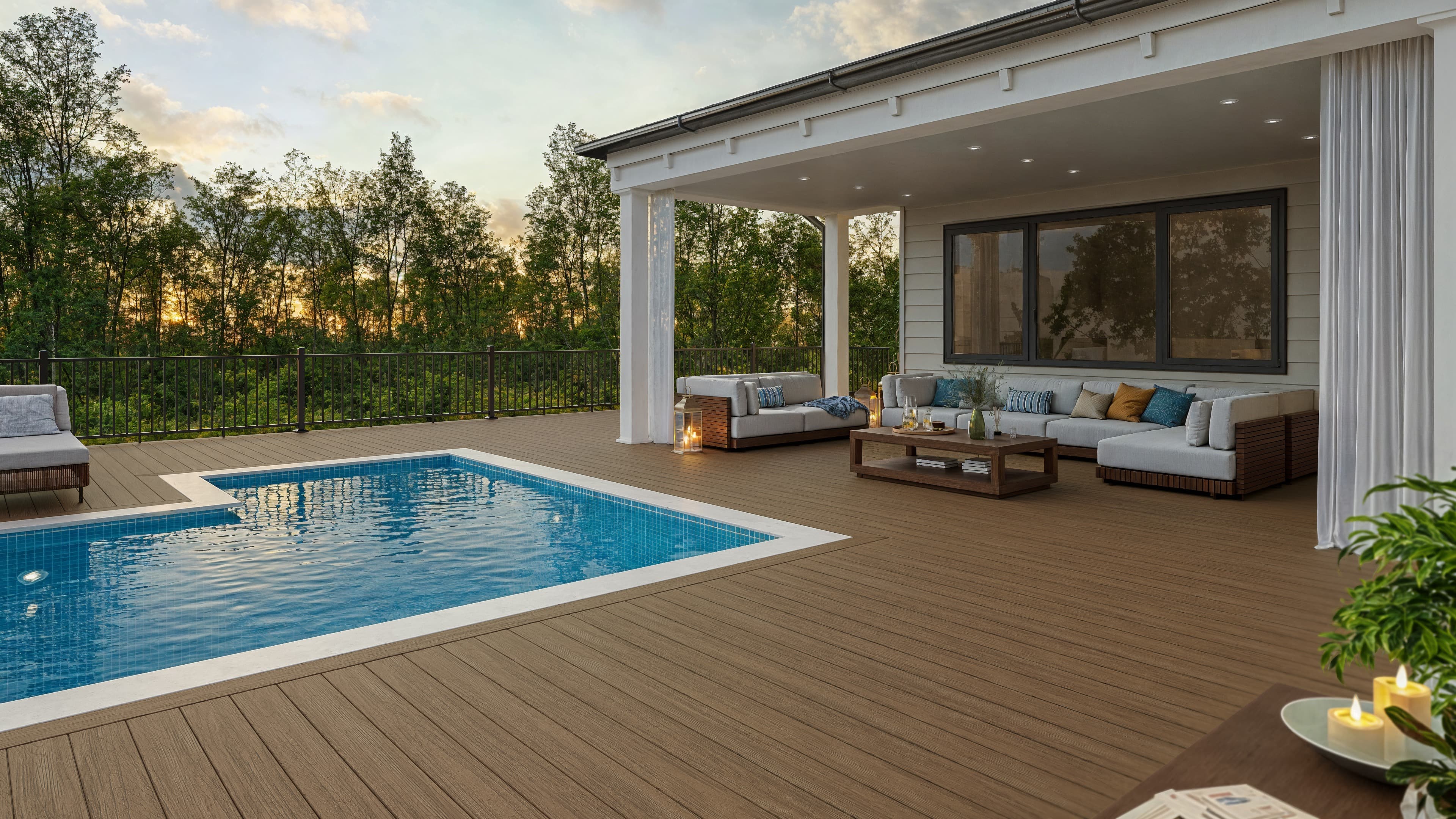 Deckorators Summit Boulder decking with textured black aluminum railing by a pool